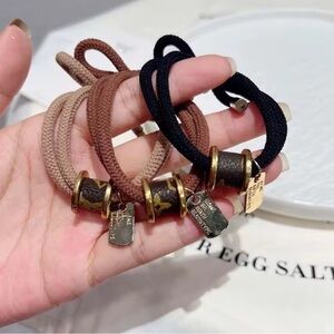 Elegant and Stylish Dark Brown Hair Tie with Gold Accents